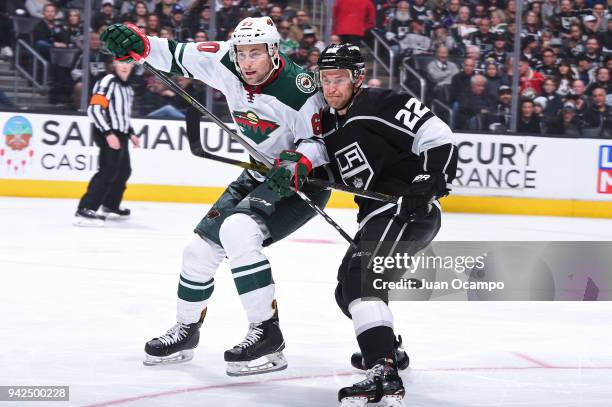 Trevor Lewis of the Los Angeles Kings skates against Carson Soucy of the Minnesota Wild at STAPLES Center on April 5, 2018 in Los Angeles, California.