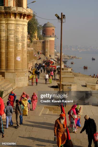 People walk past Ganga Mahal Ghat on the banks of Ganga River on January 31, 2018 in Varanasi, India. Varanasi is a major religious hub in India, it...