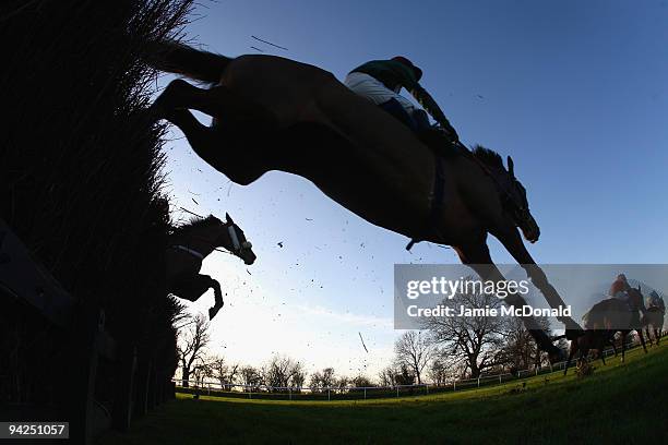 Horses and riders jump the ditch during the Peterborough Steeple Chase run at Huntingdon Racecourse on December 10, 2009 in Huntingdon, England.