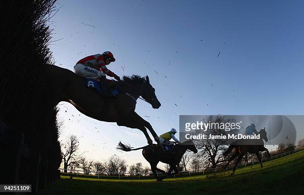 Horses and riders jump the ditch during the Peterborough Steeple Chase run at Huntingdon Racecourse on December 10, 2009 in Huntingdon, England.