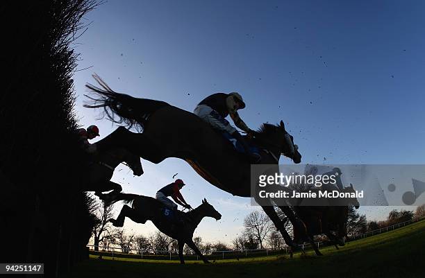 Horses and riders jump the ditch during the Peterborough Steeple Chase run at Huntingdon Racecourse on December 10, 2009 in Huntingdon, England.