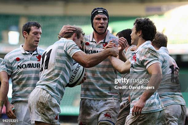 James Greenwood of Cambridge is congratulated by his captain Dan Vickerman after scoring a try during the Nomura Varsity match between Oxford...