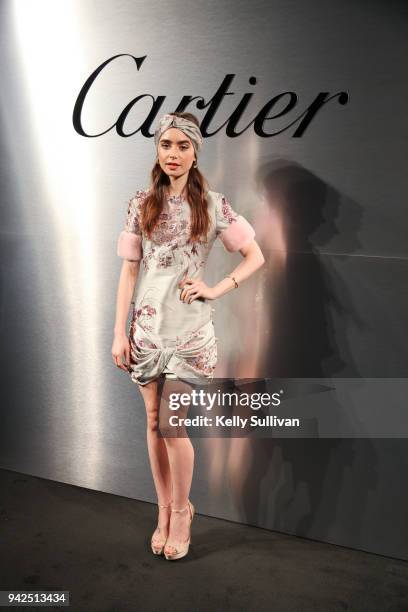 Actress Lily Collins arrives on the red carpet for the Santos de Cartier Watch Launch at Pier 48 on April 5, 2018 in San Francisco, California.