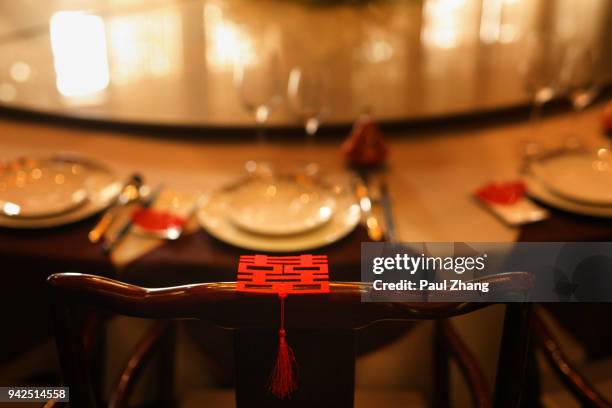 chinese paper-cut with chinese characters "double happiness" on the dinning table - double happiness stock pictures, royalty-free photos & images