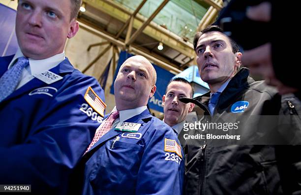Tim Armstrong, chairman and chief executive officer of AOL Inc., right, stands with Evan Solomon, center, and Edward Zelles, left, at the post where...