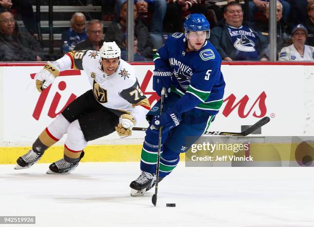 April 3: Ryan Reaves of the Vegas Golden Knights looks on as Derrick Pouliot of the Vancouver Canucks skates up ice with the puck during their NHL...