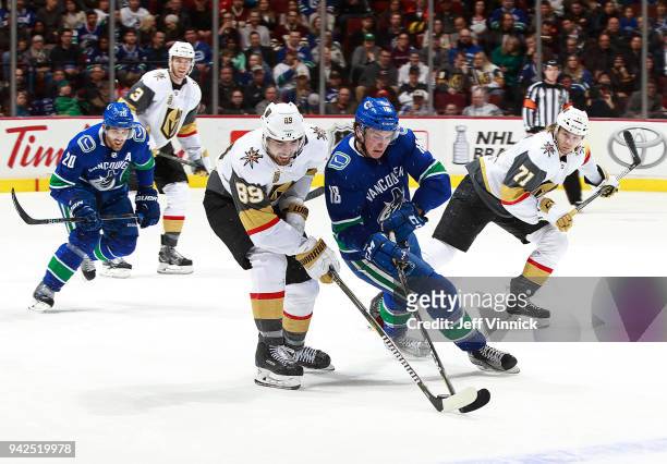 April 3: Alex Tuch of the Vegas Golden Knights checks Jake Virtanen of the Vancouver Canucks during their NHL game at Rogers Arena April 3, 2018 in...