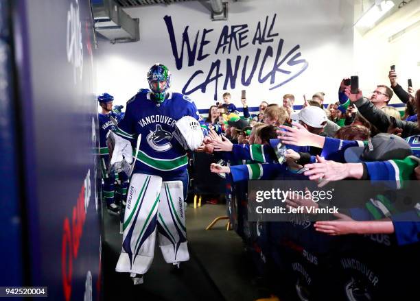 April 3: Jacob Markstrom of the Vancouver Canucks walks past fans to the ice during their NHL game against the Vegas Golden Knights at Rogers Arena...