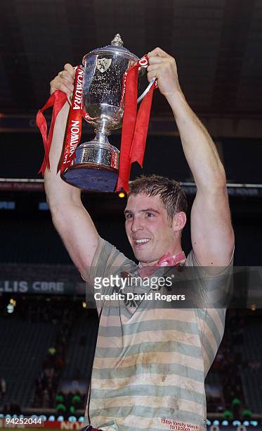 Dan Vickerman, the Cambridge captain, raises the trophy after their victory in the Nomura Varsity match between Oxford University and Cambridge...