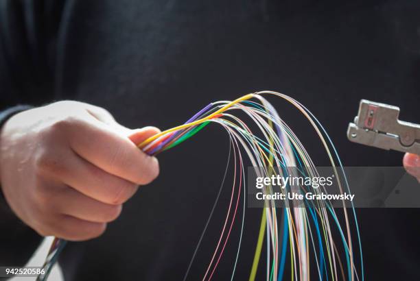 March 14: An employee of Deutsche Glasfaser is splicing fiber optic cables, which are layed in rural areas in a FTTH process on March 14, 2018 in...