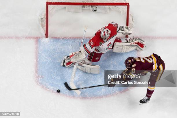 Sean Romeo of the Ohio State Buckeyes protects the goal against Karson Kuhlman of the Minnesota-Duluth Bulldogs during the Division I Men's Ice...