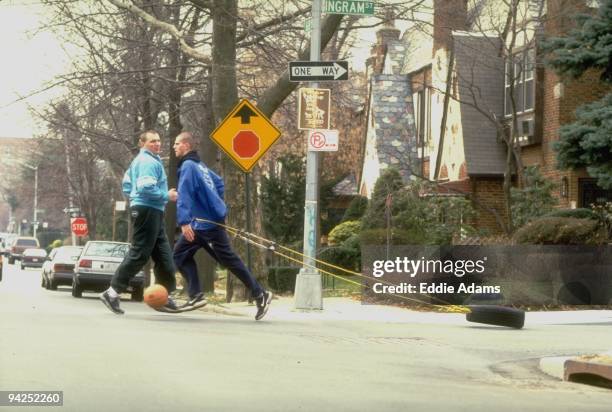High School Basketball: Dwight HS Vedad Ozmanovic dribbling ball and dragging tire as his trainer Radomir Kovacevic watches at 68th Avenue and Ingram...