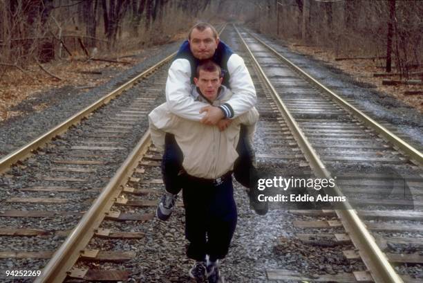 High School Basketball: Casual portrait of Dwight HS Vedad Ozmanovic carrying his trainer Radomir Kovacevic on railroad tracks in Queens. New York...