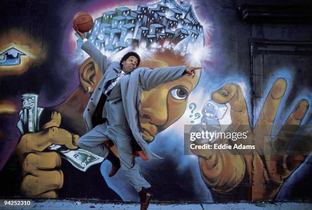 High School Basketball: Portrait of playground legend and Dwight HS coach Pee Wee Kirkland with ball in front of mural at 110th st and Fifth Avenue...