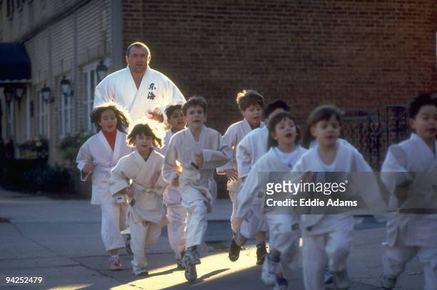 High School Basketball: Dwight HS athletic chancellor Radomir Kovacevic jogging with his youth judo students during workout. New York, NY 1/21/1998...