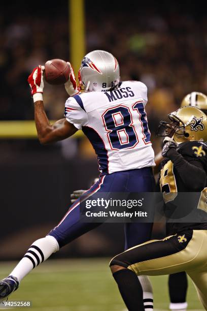 Wide receiver Randy Moss of the New England Patriots catches a pass against the New Orleans Saints at the Louisiana Superdome on November 30, 2009 in...