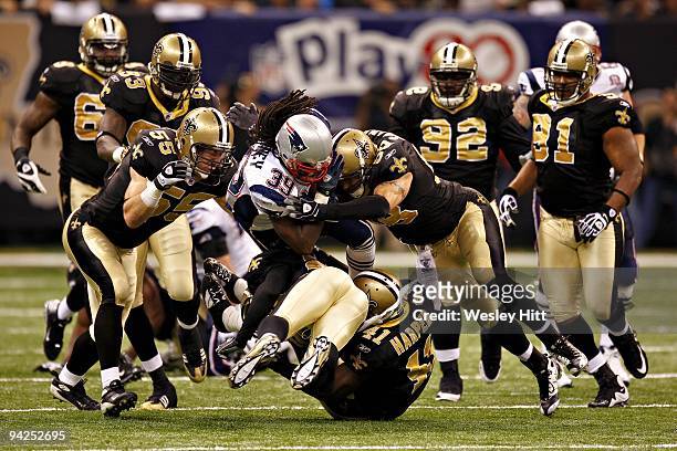 Running back Laurence Maroney of the New England Patriots is tackled by the defense of the New Orleans Saints at the Louisiana Superdome on November...