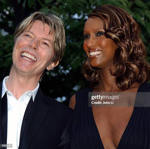 Singer David Bowie and his wife Iman attend the Serpentine Gallery Summer Party at the Serpentine Gallery in Kensington Gardens July 9, 2002 in...