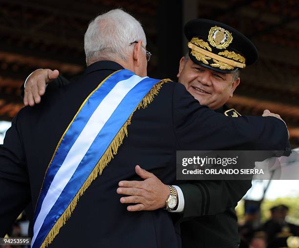 Honduran de facto President Roberto Micheletti embraces Chief of Army General Staff Gen Romeo Vasquez after decorating him during a ceremony in...