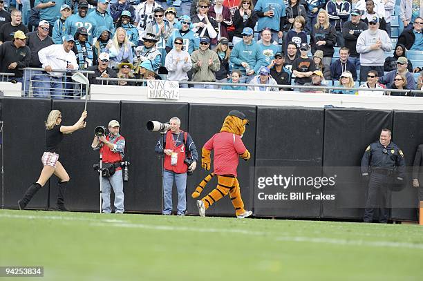 View of actress portraying Elin Woods chasing mascot dressed like Tiger Woods during Jacksonville Jaguars vs Houston Texans game. The skit references...