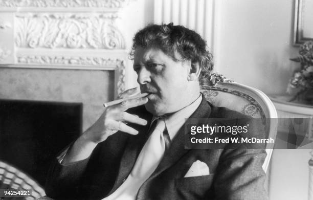 English author and linguist Anthony Burgess smokes as he sits in a chair, New York, New York, January 12, 1972.