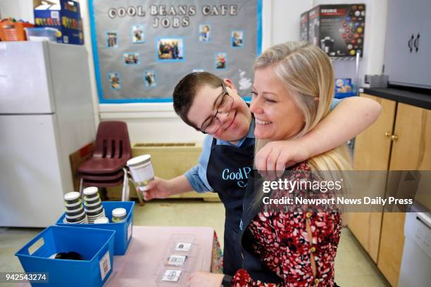 Jake Mann hugs Betsy Ferguson while working at Poquoson Middle School's Cool Beans Cafe on Thursday morning, March 29, 2018. Special needs students...