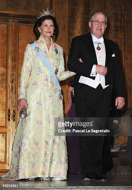 Queen Silvia of Sweden arrives with Marcus Storch, Chairman of the Board of the Nobel Foundation during the Nobel Foundation Prize Banquet 2009 at...