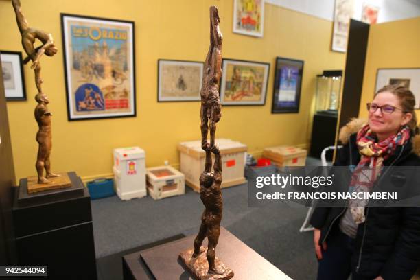 Woman looks at sculptures on display, during the exhibition "Acrobates" , to mark the 250th anniversary of the modern circus, at the Beaux-Arts...