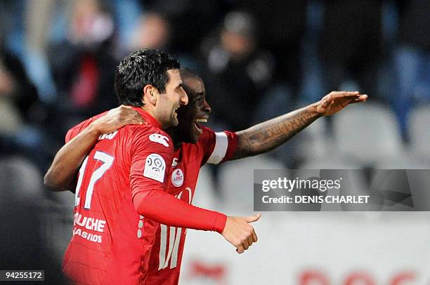 Lille's forward Pierre Alain Frau is congratuled by teammate midfielder Antonio Mavuba after scoring a goal during the French L1 football match Lille...
