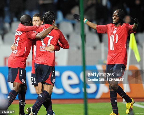 Lille's forward Pierre Alain Frau is congratuled by teammates after scoring a goal during the French L1 football match Lille vs Bordeaux on December...