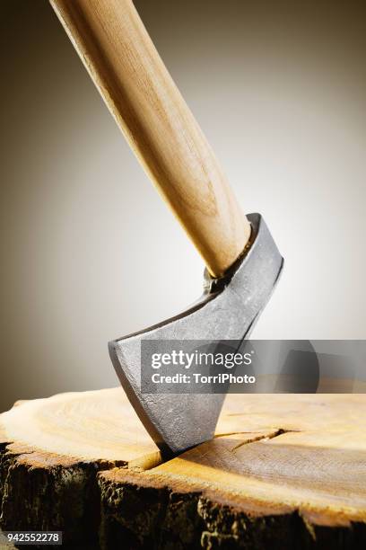 hand axe with wooden handle in the stump on gradient brown background - axe stock pictures, royalty-free photos & images
