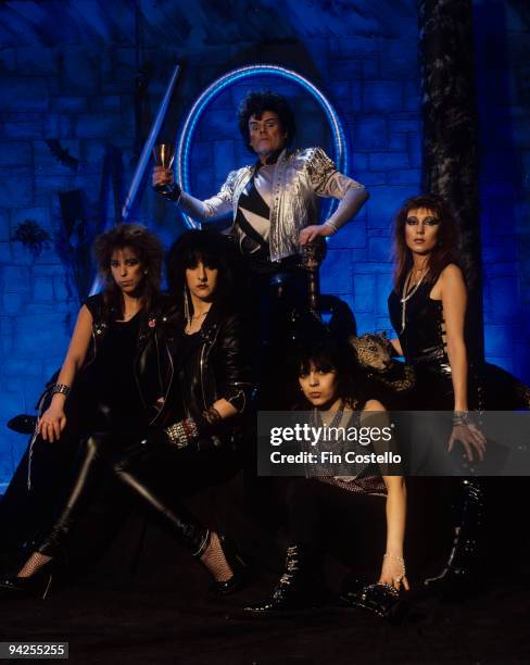 Posed group portrait of Gary Glitter with Girlschool in 1986.