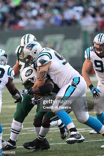 Running Back Thomas Jones of the New York Jets is stopped by Defensive Tackle Nick Hayden of the Carolina Panthers as he runs the ball at Giants...