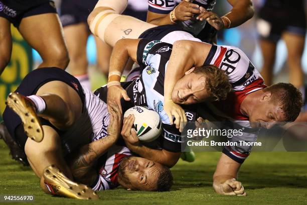 Matthew Moylan of the Sharks is tackled by Roosters defence during the round five NRL match between the Cronulla Sharks and the Sydney Roosters at...