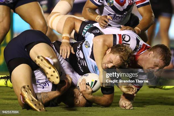 Matthew Moylan of the Sharks is tackled by Roosters defence during the round five NRL match between the Cronulla Sharks and the Sydney Roosters at...