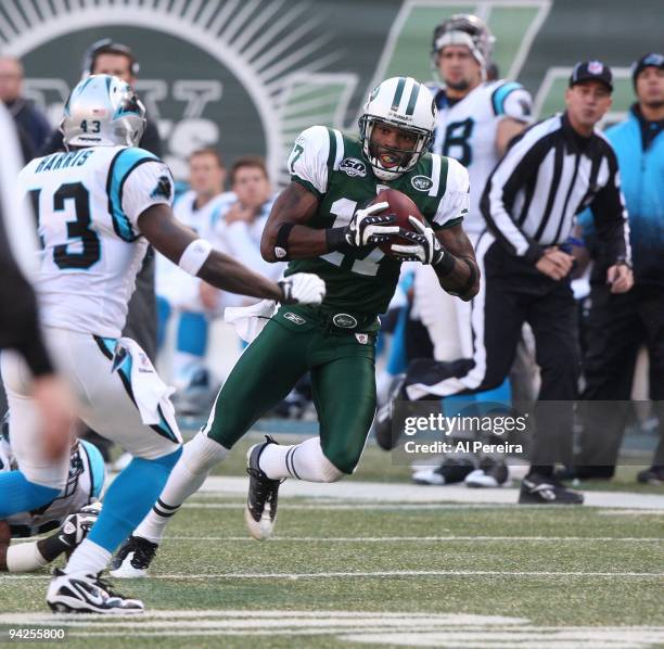 Wide Receiver Braylon Edwards of the New York Jets has a long gain against the Carolina Panthers at Giants Stadium on November 29, 2009 in East...