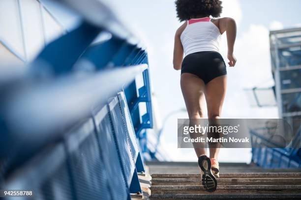 sporty woman running upstairs - fitness concept - female backside stock pictures, royalty-free photos & images
