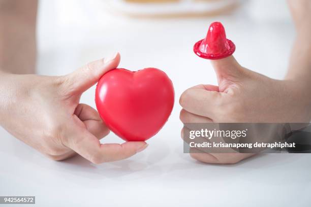 condom with heart - hiv prevention stock pictures, royalty-free photos & images