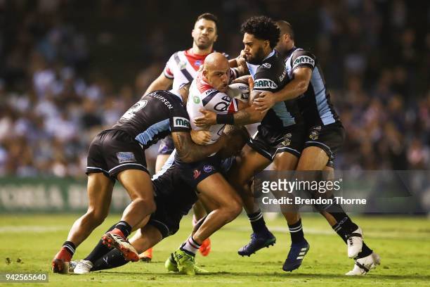 Blake Ferguson of the Roosters is tackled by the Sharks defence during the round five NRL match between the Cronulla Sharks and the Sydney Roosters...