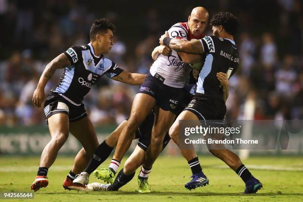 Blake Ferguson of the Roosters is tackled by the Sharks defence during the round five NRL match between the Cronulla Sharks and the Sydney Roosters...