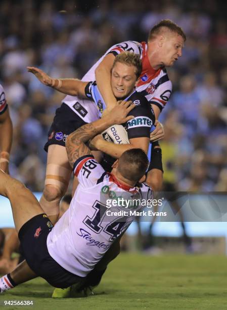 Matt Moylan of the Sharks is tacked by Dylan Napa and Jared Waerea-Hargreaves of the Roosters during the round five NRL match between the Cronulla...