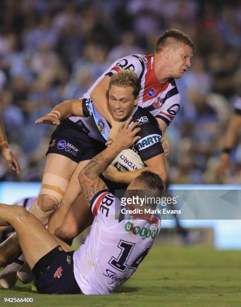 Matt Moylan of the Sharks is tacked by Dylan Napa and Jared Waerea-Hargreaves of the Roosters during the round five NRL match between the Cronulla...