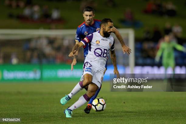 Diego Castro of Perth Glory is contested by Jason Hoffman of the Jets during the round 26 A-League match between the Newcastle jets and the Perth...