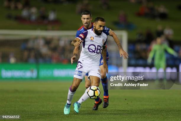 Diego Castro of Perth Glory is contested by Jason Hoffman of the Jets during the round 26 A-League match between the Newcastle jets and the Perth...