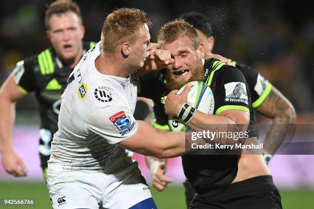 Brad Shields of the Hurricanes is tackled by Jean-Luc du Preez of the Sharks during the round eight Super Rugby match between the Hurricanes and the...