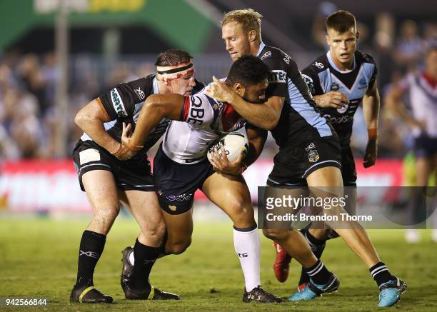 Isaac Liu of the Roosters is tackled by the Sharks defence during the round five NRL match between the Cronulla Sharks and the Sydney Roosters at...