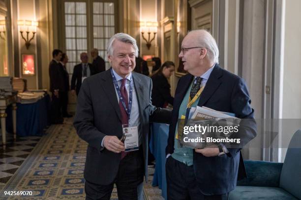 Ferruccio de Bortoli, editor-in-chief of RCS Mediagroup SpA, left, speaks to attendee during the 29th edition of "The Outlook for the Economy and...