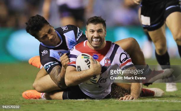 James Tedesco of the Roosters is tacked by Sosaia Feki of the Sharks during the round five NRL match between the Cronulla Sharks and the Sydney...