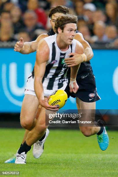 Levi Casboult of the Blues tackles Matt Scharenberg of the Magpies during the round three AFL match between the Carlton Blues and the Collingwood...