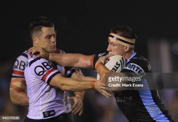 Paul Gallen of the Sharks fends off Cooper Cronk of the Roosters during the round five NRL match between the Cronulla Sharks and the Sydney Roosters...